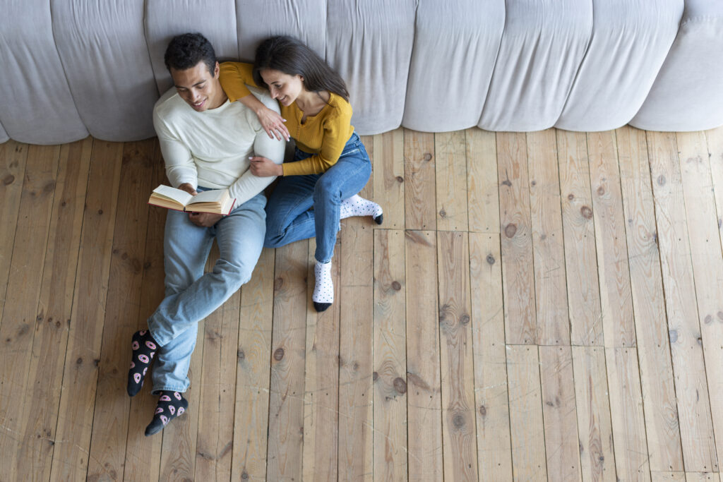 couple reading a book on floors about floor installation services